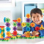 Child playing with Learning Resources Gears Gears Gears Deluxe Building Set
