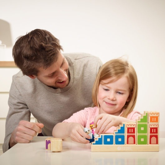 A young girl and her father play Camleot Junior