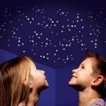 Children looking at glowing stars on the ceiling