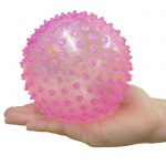 Pink inflatable ball in a hand for scale