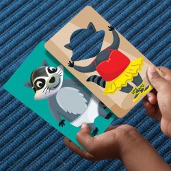 A child placing a profession card onto a racoon wearing underpants!