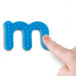 Child's finger tracing the arrows on an M from the Learning Resources Tactile Letters Set