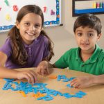 2 children playing with the Learning Resources Tactile Letters Set