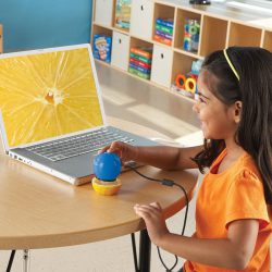Child looking at a lemon using the Zoomy 2.0 Handheld Digital Microscope