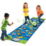 Three children playing with the Learning Resources Crocodile Hop Early Maths Floor Game