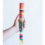 A child's hand holding the Plus Plus Neon Mix Tube