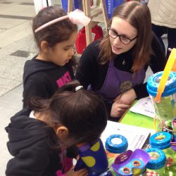 Children and Fun Learning Staff Member testing out Learning Resources talking microscope