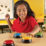 Girl hitting learning Resources buzzers