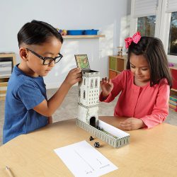 Children rolling the dice to play Learning Resources Secret Dice Tower