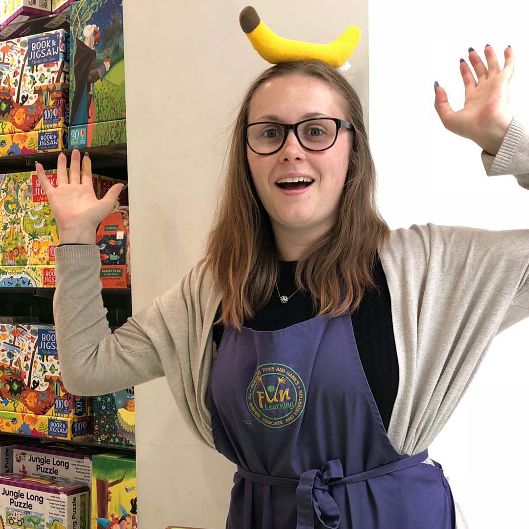 A Fun Learning staff member Monkeying Around with a banana on her head