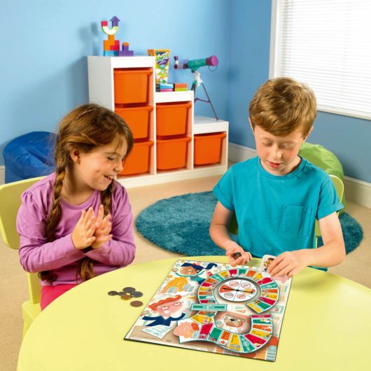 Two children playing the Learning Resources Money Bags game