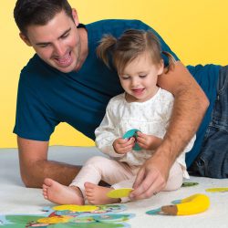 Dad plays with a toddler using Monkey Around Game