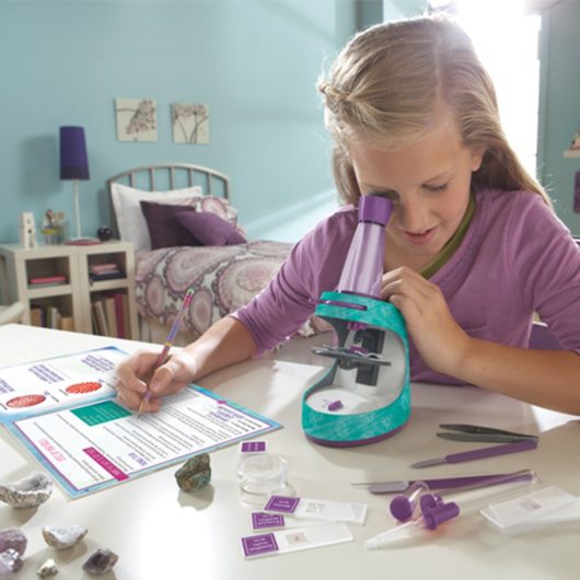 Kid using the Nancy B Microscope